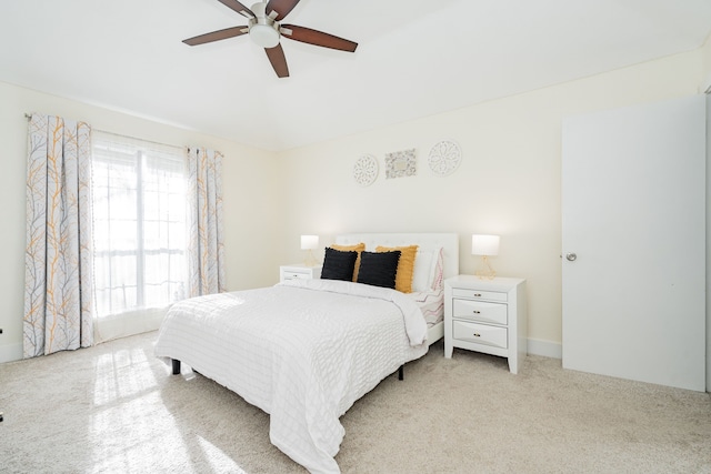 bedroom with ceiling fan and light colored carpet