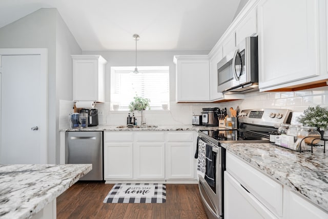 kitchen featuring decorative light fixtures, stainless steel appliances, white cabinetry, and sink