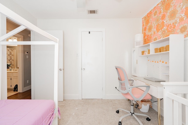 carpeted bedroom featuring a crib