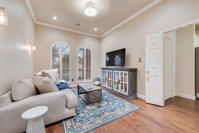 living room with hardwood / wood-style floors and ornamental molding