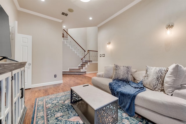 living room with crown molding and wood-type flooring