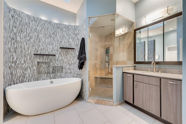 bathroom with separate shower and tub, tile patterned flooring, vanity, and tile walls