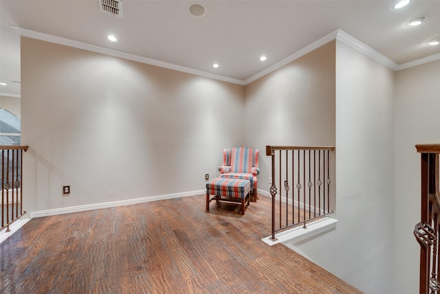 sitting room featuring wood-type flooring and ornamental molding