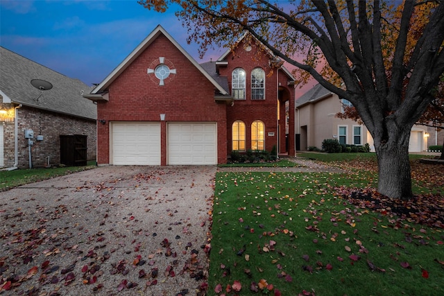 view of front property featuring a garage and a lawn