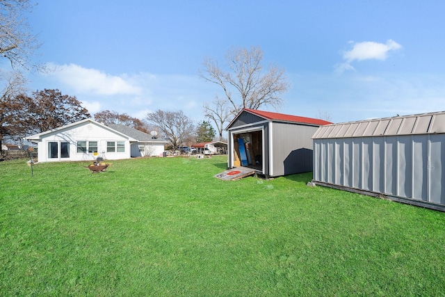 view of yard with a storage shed and an outdoor structure