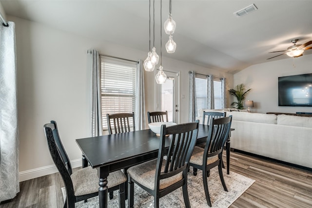 dining space featuring wood-type flooring, ceiling fan, and lofted ceiling