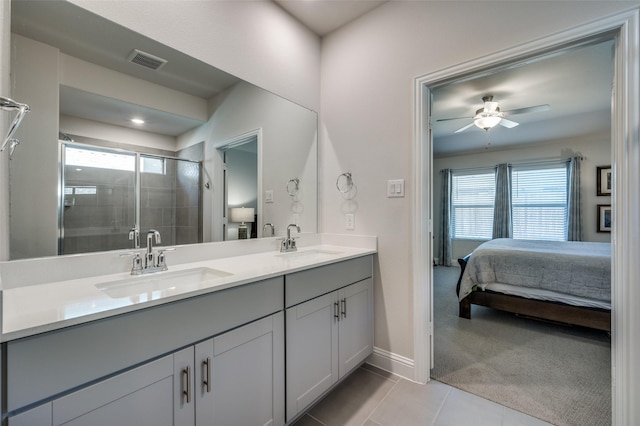 bathroom with a shower with shower door, tile patterned floors, vanity, and ceiling fan