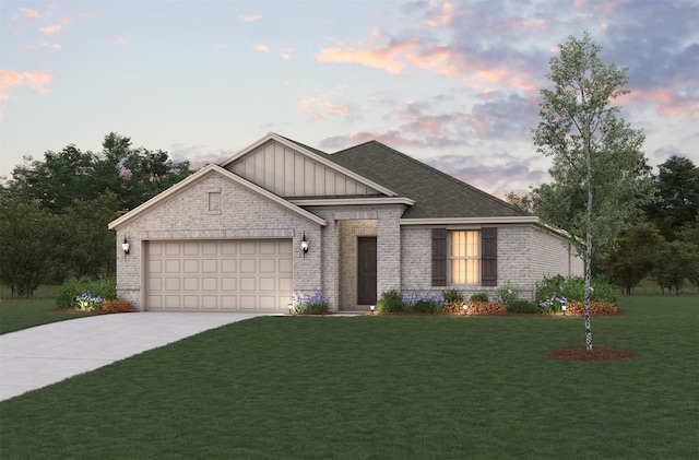 view of front of property with a garage and a lawn