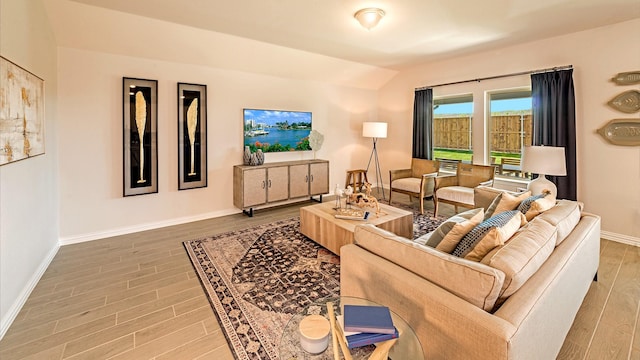 living room featuring hardwood / wood-style flooring and lofted ceiling