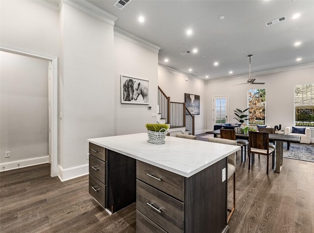 living room featuring hardwood / wood-style floors and crown molding