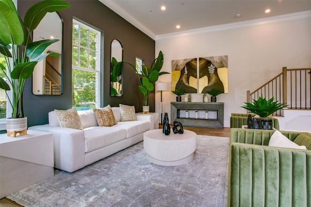 living room featuring hardwood / wood-style flooring and ornamental molding