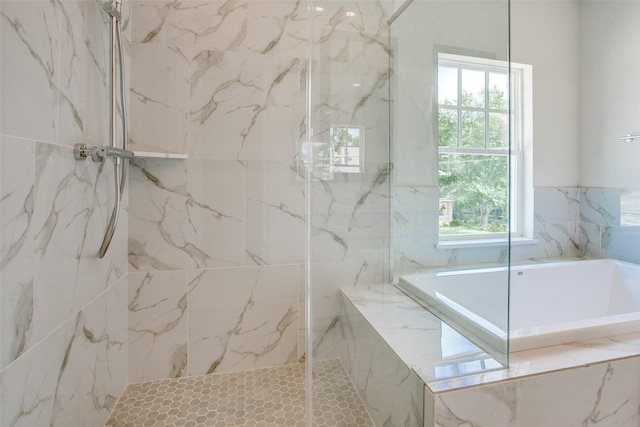 bathroom featuring shower with separate bathtub