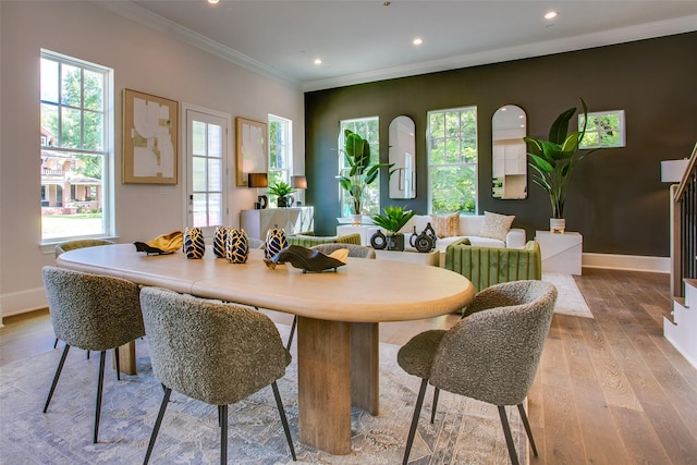 dining area with plenty of natural light, light hardwood / wood-style floors, and ornamental molding