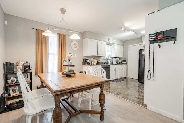 dining area featuring sink and light hardwood / wood-style flooring