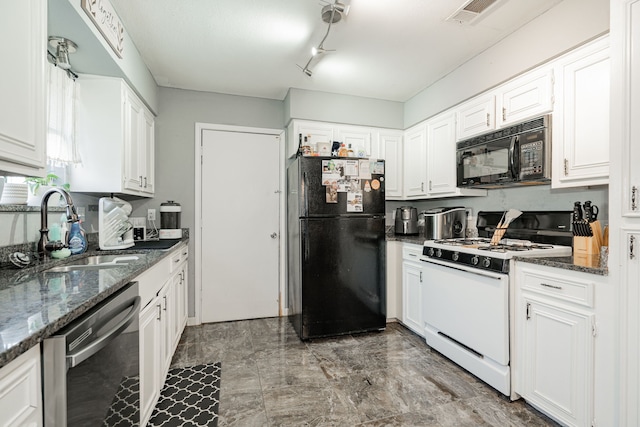 kitchen with sink, white cabinetry, dark stone counters, and black appliances