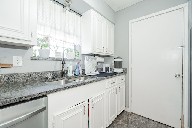 kitchen featuring dishwasher, white cabinets, and sink