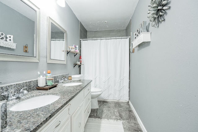 bathroom featuring curtained shower, vanity, and toilet