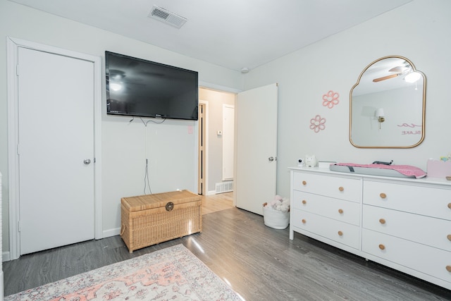 bedroom with dark hardwood / wood-style flooring