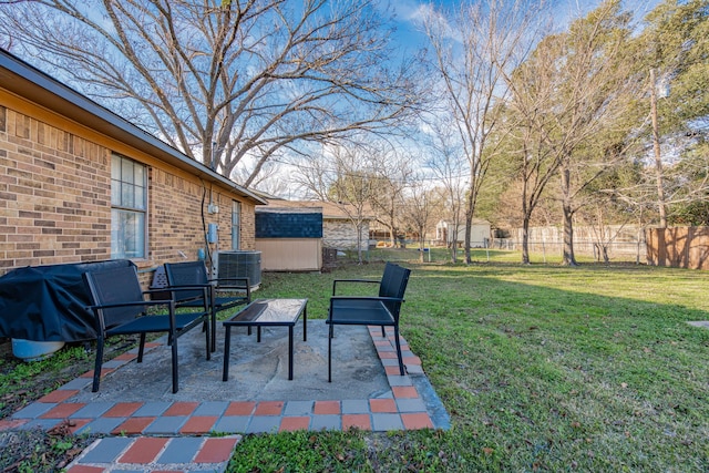 view of patio featuring cooling unit and a storage shed