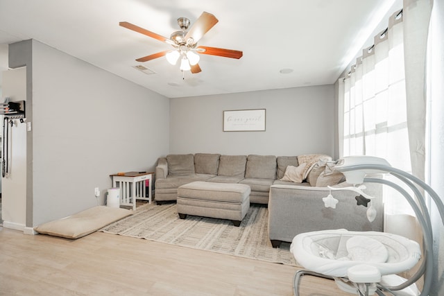 living room featuring hardwood / wood-style flooring and ceiling fan