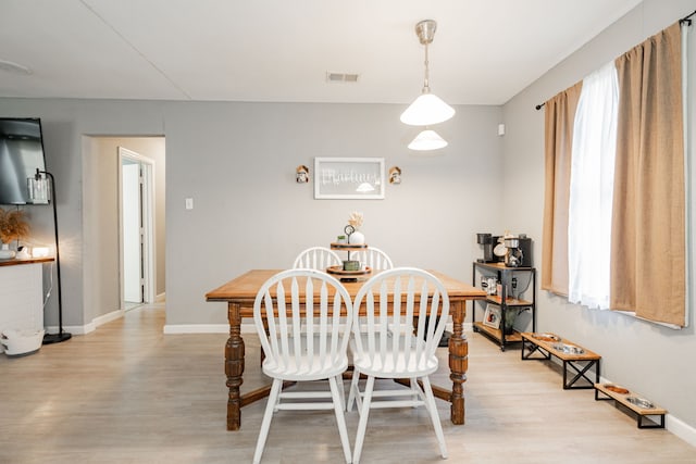 dining space with light hardwood / wood-style flooring