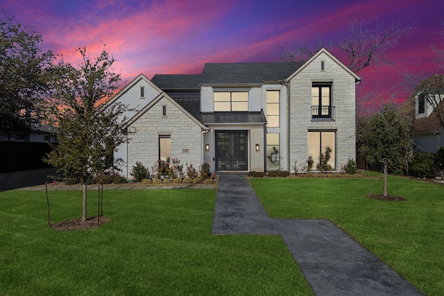 view of front of property with a yard and french doors