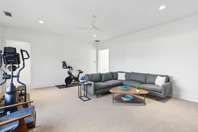 carpeted living room with ceiling fan