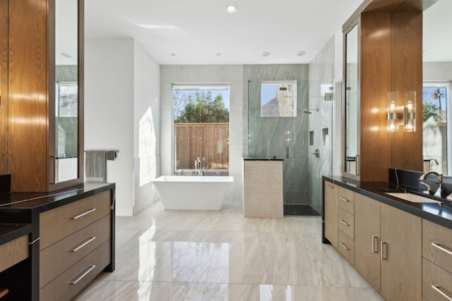 bathroom featuring vanity and separate shower and tub