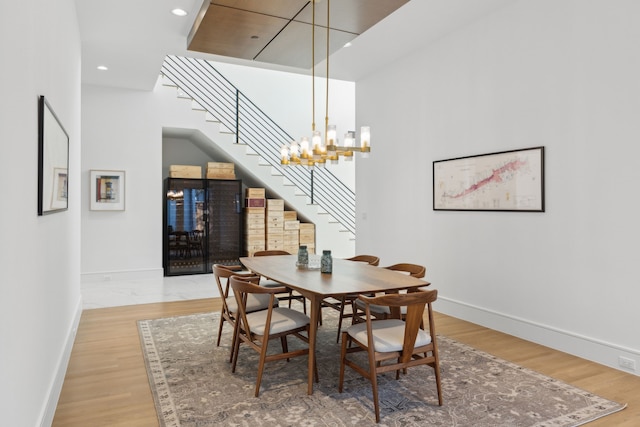 dining area featuring wood-type flooring and a chandelier