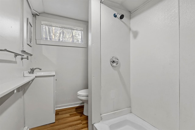 bathroom featuring walk in shower, toilet, vanity, and hardwood / wood-style flooring