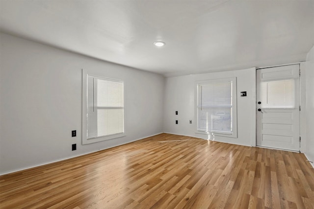 foyer entrance with light hardwood / wood-style floors and a wealth of natural light