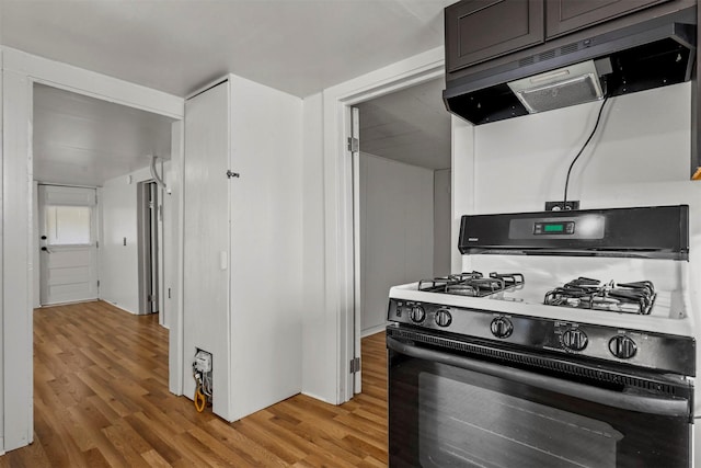 kitchen with light hardwood / wood-style floors and black gas stove