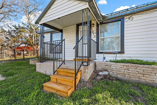 property entrance with a yard