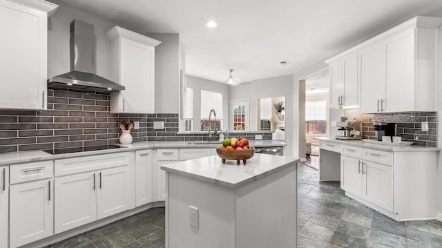 kitchen featuring white cabinets, wall chimney range hood, black electric stovetop, and a healthy amount of sunlight