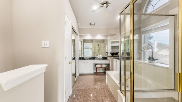 bathroom featuring ceiling fan, vanity, independent shower and bath, and a textured ceiling