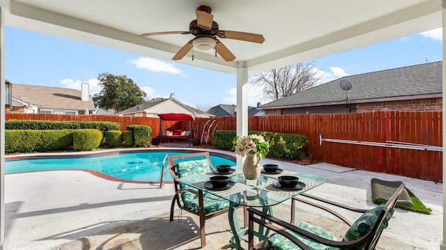 view of swimming pool featuring ceiling fan and a patio area