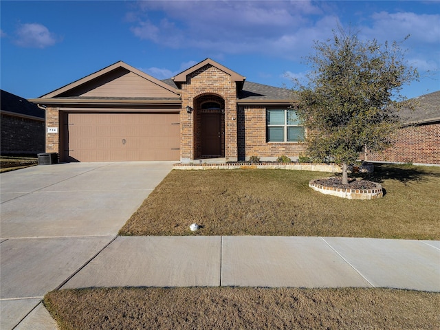 ranch-style house featuring a garage and a front lawn