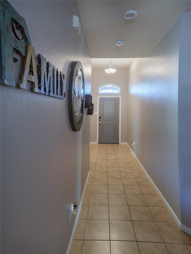 hall with light tile patterned floors