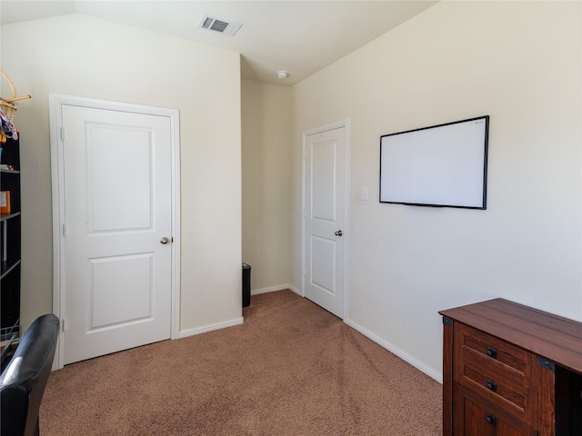 bedroom with light carpet and lofted ceiling