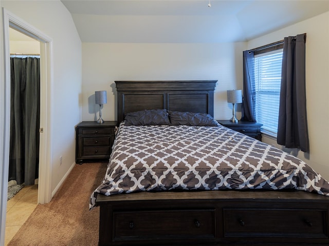 carpeted bedroom with vaulted ceiling