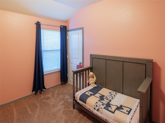 bedroom with light carpet and lofted ceiling