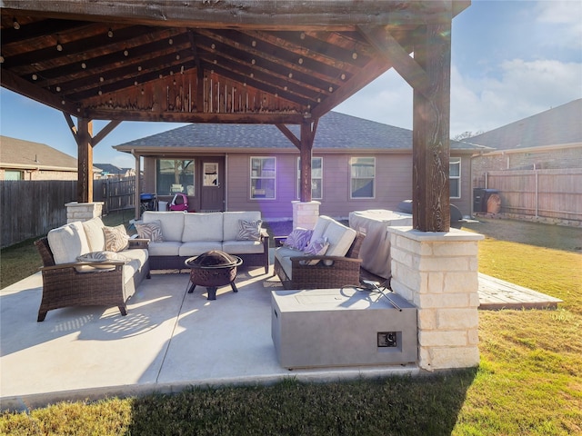 view of patio with a gazebo and an outdoor living space with a fire pit