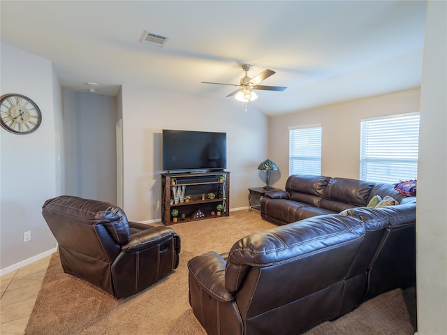 tiled living room with ceiling fan and vaulted ceiling