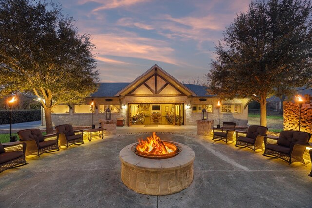 exterior space featuring a patio area and an outdoor fire pit