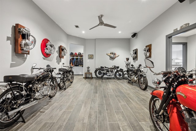 workout area with wood-type flooring and ceiling fan