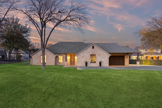 view of front of home featuring a lawn and a garage