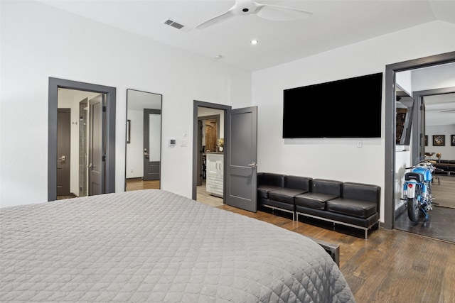 bedroom with wood-type flooring, ceiling fan, and vaulted ceiling