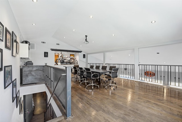 kitchen with white cabinetry, dark wood-type flooring, kitchen peninsula, and vaulted ceiling