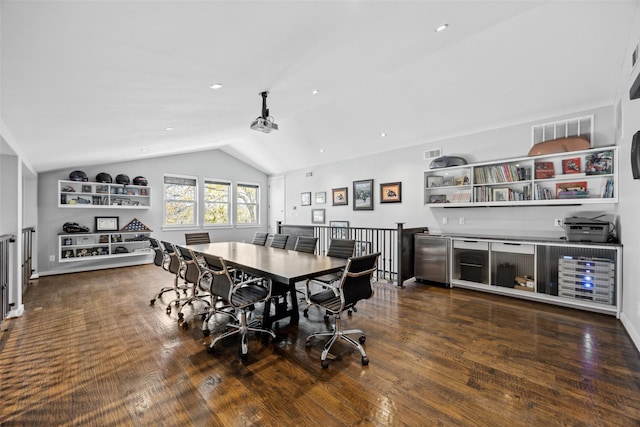 dining room featuring lofted ceiling and dark hardwood / wood-style floors