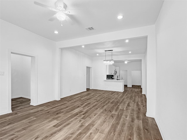 unfurnished living room featuring ceiling fan and hardwood / wood-style floors